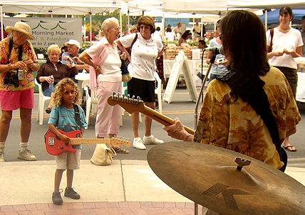 Charlie Morris Band at the Saturday Morning Market with a young fan